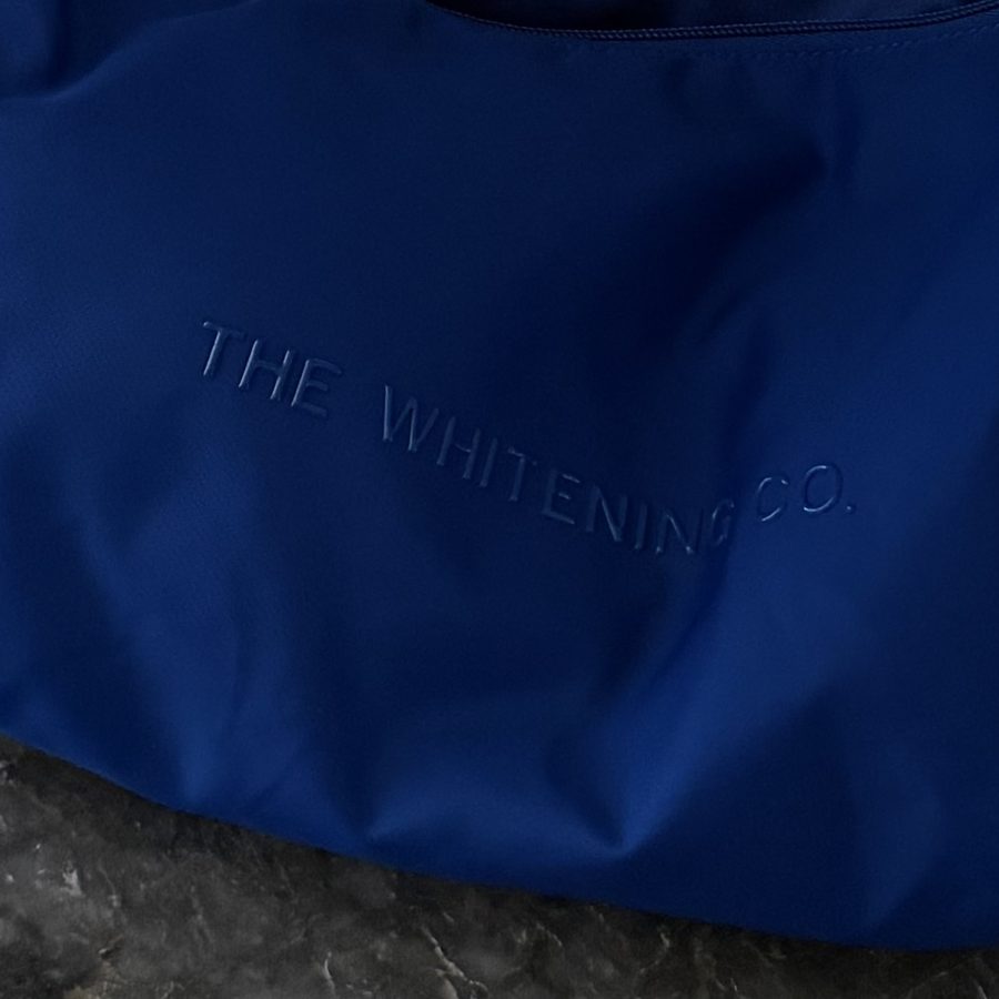 Tonal embossed THE WHITENING CO. logo on the Cobalt Beauty Bag