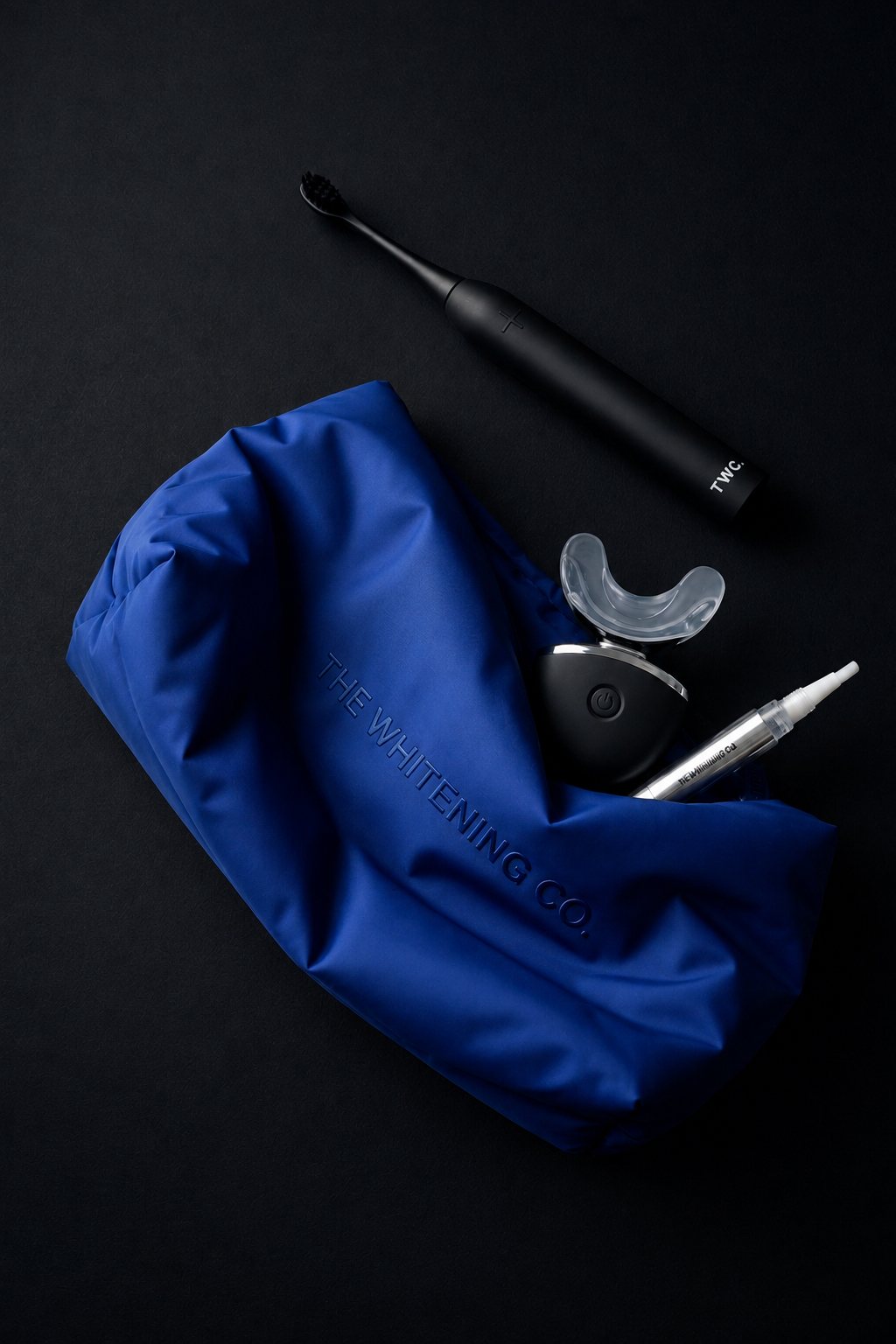The Beauty Bag in Cobalt with an E-Brush, whitening light and pen